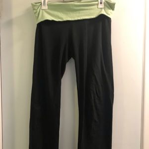 Yoga pants with a green fold over waistband